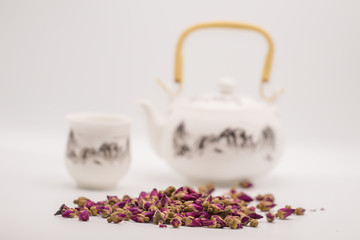 Dried rose petal flower on isolate white background.Blurred close up flower buds and tea on white background.