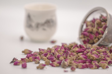 Dried rose petal flower on isolate white background.Blurred close up flower buds and tea on white background.