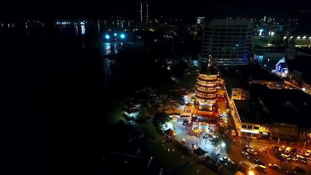 Night Aerial View of a Chinese Template next to the sea in the city of Kota Kinabalu - Malaysia - Aerial -  Dolly Backwards 