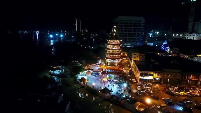 Night View of a Chinese Temple next to sea In Kota Kinabalu - Malaysia - Aerial - Left Dolly 
