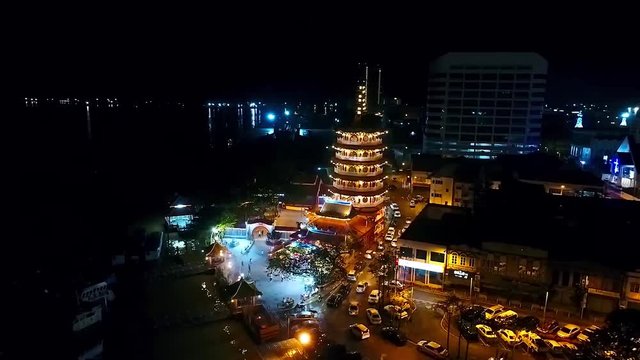 Top Night View of a Chinese Temple next to the sea In Kota Kinabalu - Malaysia - Aerial - Left Dolly 