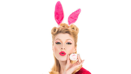 Obraz na płótnie Canvas Happy woman preparing for Easter. Easter egg hunting. Pretty girl hunts for Easter eggs. Hand with color Easter eggs. Bunny ears concept.