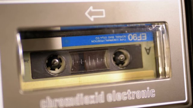 Vintage Audio Cassette in the Tape Recorder Playing and Rotates