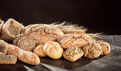 Fresh bread assortment on dark surface