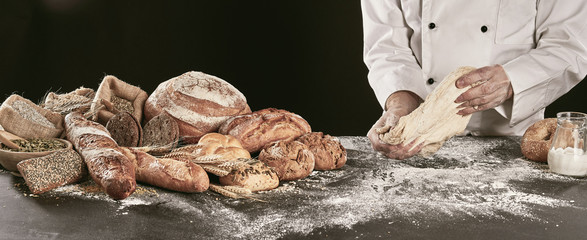 Chef kneading dough while making speciality bread