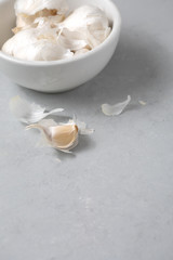 Fototapeta na wymiar Garlic Bulbs with Garlic Clove on Gray Counter