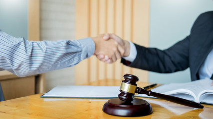 Law and Legal concept, Consultation between attorneys and clients customer shaking hands discussing contract agreement In Courtroom.