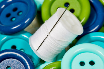 Spool of Thread with blue, green and Aqua Buttons