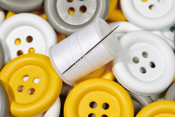 Spool of Thread with Yellow, White and Gray Buttons