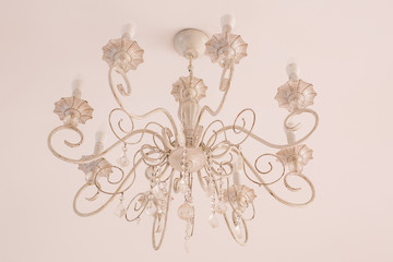 Interior and lamps concept - White chandelier in vintage style