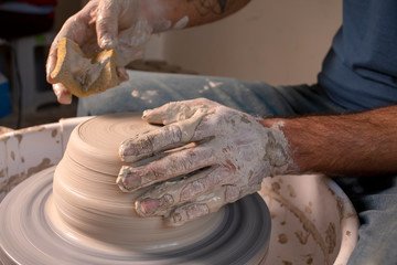 Professional potter making bowl in pottery workshop