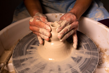 Fototapeta na wymiar Professional potter making bowl in pottery workshop