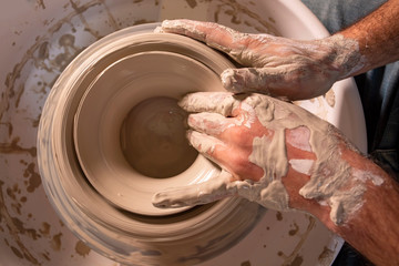 Professional potter making bowl in pottery workshop