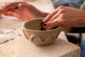 Professional potter making bowl in pottery workshop