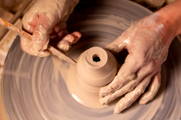 Professional potter making bowl in pottery workshop