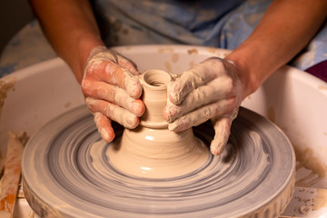 Professional potter making bowl in pottery workshop