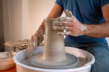 Professional potter making bowl in pottery workshop