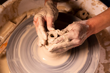 Professional potter making bowl in pottery workshop