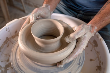 Fototapeta na wymiar Professional potter making bowl in pottery workshop