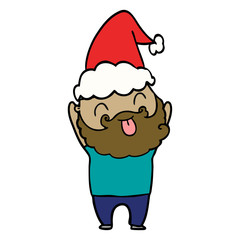 man with beard sticking out tongue wearing santa hat