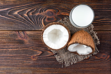 Coconut milk on dark wooden background.