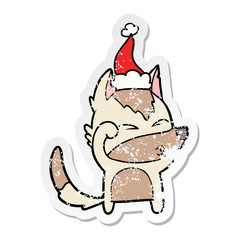 distressed sticker cartoon of a wolf pouting wearing santa hat