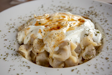 Traditional delicious Turkish foods; Manti . Food concept photo.