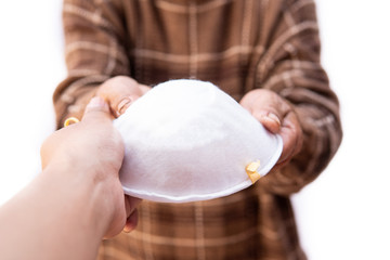 Hand giving a mask for anti pollution in the air.