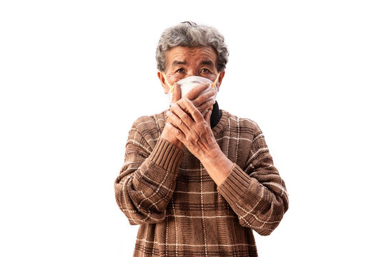 Old Woman Wearing A Mask Fear Problem Air Pollution On A White Background, Healthcare Concept.