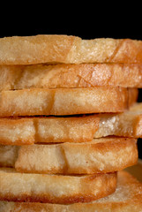 White toasted bread stacked in a pile on a plate. Shallow depth of field