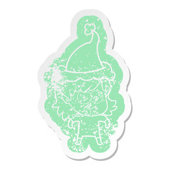 cartoon distressed sticker of a elf girl staring wearing santa hat