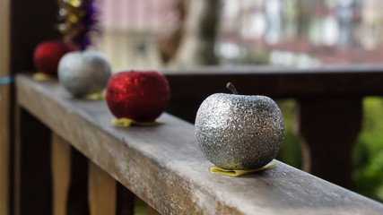 A decorative glitter silver apple on the wooden table