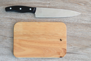 Chef's knife and Chopping board on wood table.