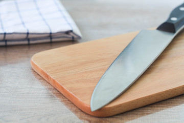 Chef's knife and Chopping board on wood table.