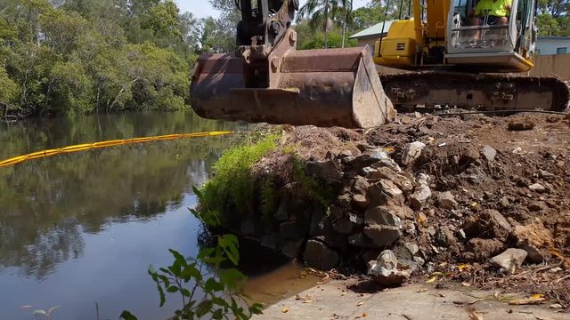 Heavy machinery excavating soil and rock on a construction site