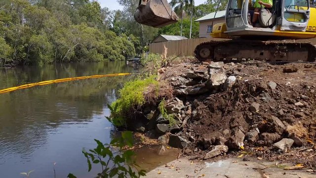 Heavy machinery excavating soil and rock on a construction site