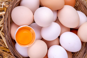 Raw eggs in dry straw. Food concept photo.