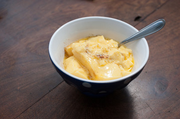 home made vanilla and cinnamon flan over a wooden table