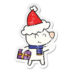 female polar bear with christmas present wearing santa hat