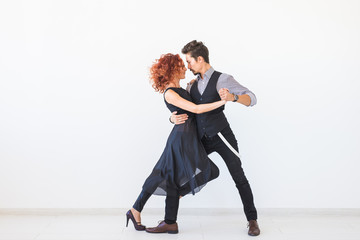 Social dance, kizomba, tango, salsa, people concept - beautiful couple dancing bachata on white background with copy space