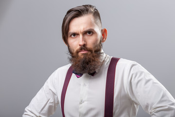 People, style and fashion concept - Portrait of bearded man dressed in white shirt over grey background