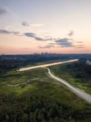 Aerial view of Burnaby Lake in the modern city during a vibrant summer sunset. Taken in Vancouver, BC, Canada.