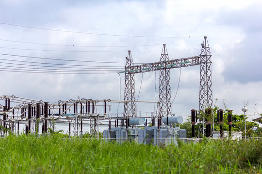 high voltage electric power substation with cloudy dark sky background