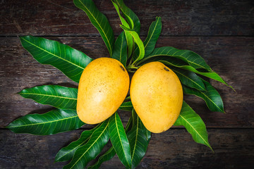 Mango. Tropical Fruits. On a wooden background. Top view.