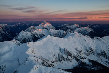 Aerial view of Canadian Mountain Landscape during a vibrant sunset. Taken North of Vancouver, British Columbia, Canada.