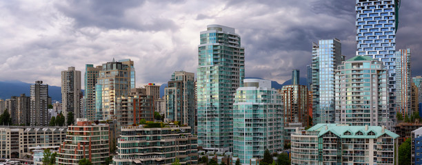 Panoramic view of Downtown City Buildings during a vibrant evening. Taken in Vancouver, British Columbia, Canada.