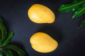 Mango. Tropical Fruits. On a wooden background. Top view.