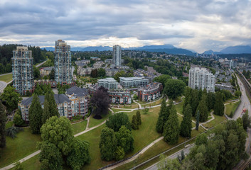 Aerial view of residential homes in a modern city during a vibrant summer sunset. Taken in New Westminster, Vancouver, BC, Canada.