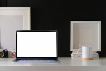 Mockup open laptop on white minimal workspace desk