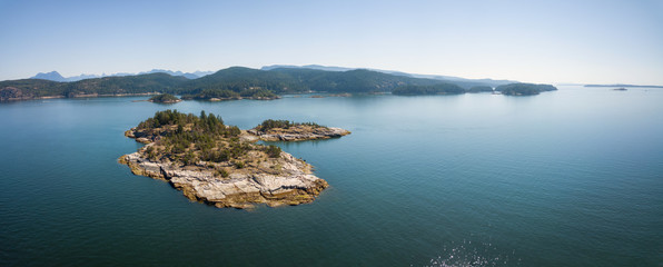 Aerial panoramic view of a rocky island during a vibrant sunny summer day. Taken near Powell River,...